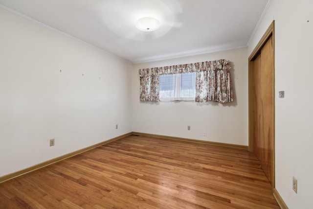 spare room with hardwood / wood-style floors and ornamental molding