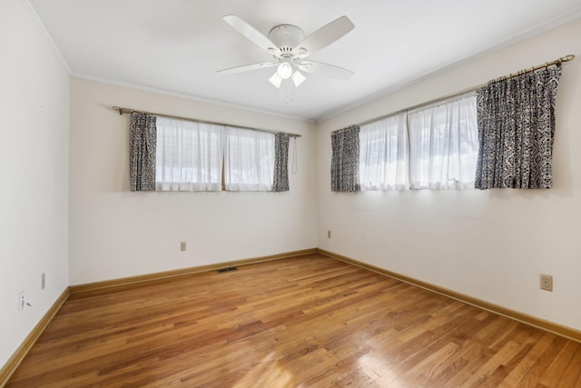 unfurnished room with ornamental molding, hardwood / wood-style floors, and ceiling fan