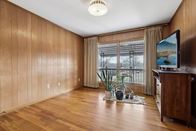 interior space with wooden walls and light wood-type flooring