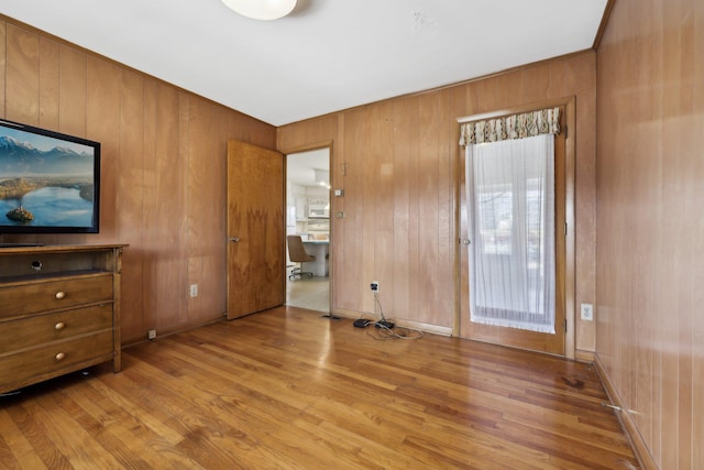 interior space with wooden walls and light wood-type flooring