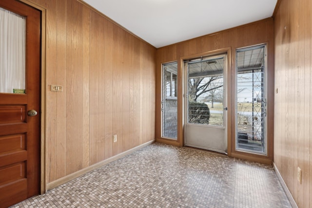 entryway with wood walls