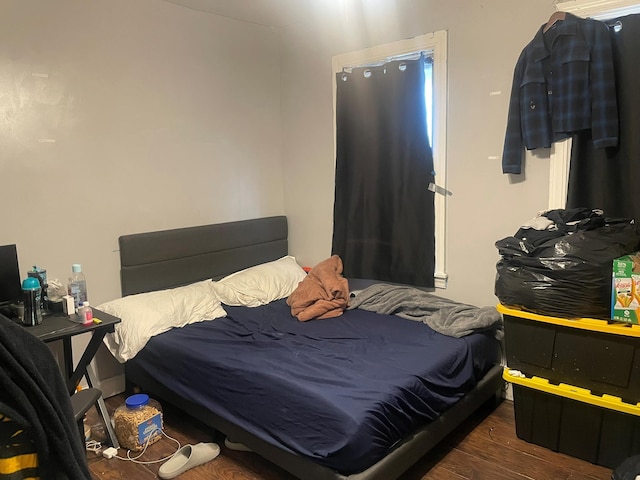 bedroom with dark hardwood / wood-style floors