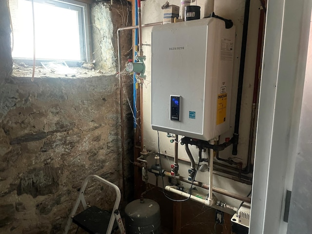 utility room featuring tankless water heater