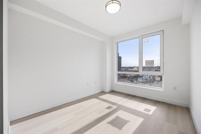 spare room with light hardwood / wood-style flooring