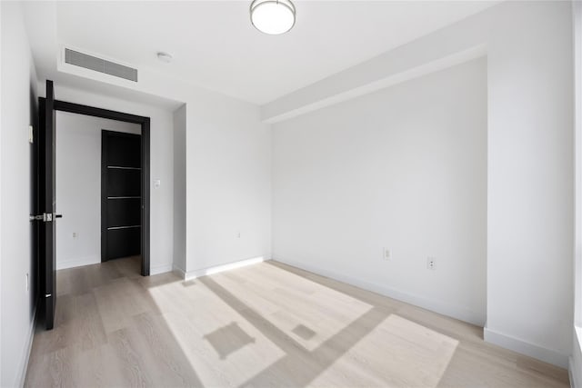 spare room featuring light hardwood / wood-style flooring