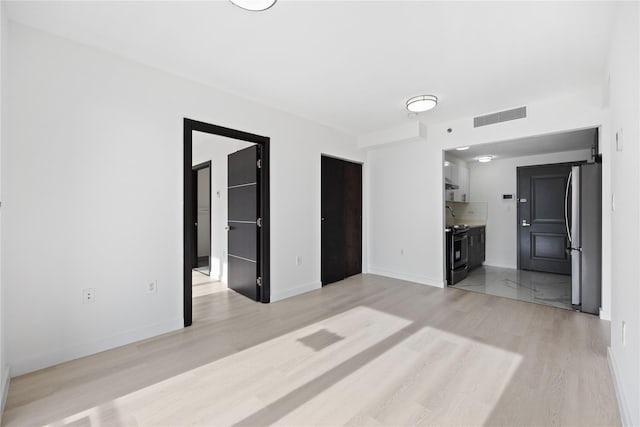 unfurnished living room featuring light hardwood / wood-style floors