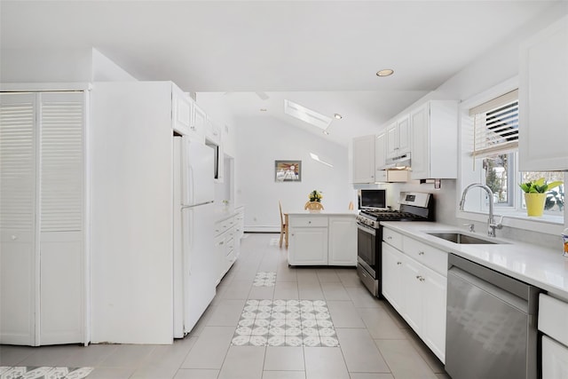 kitchen featuring appliances with stainless steel finishes, lofted ceiling, sink, white cabinets, and light tile patterned floors