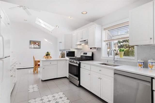 kitchen featuring sink, a baseboard radiator, kitchen peninsula, stainless steel appliances, and white cabinets