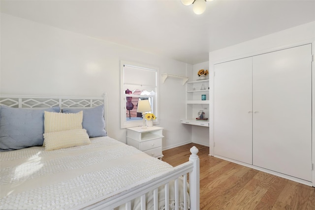 bedroom with a closet and light hardwood / wood-style flooring