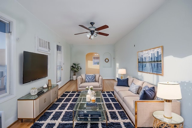 living room with ceiling fan and light hardwood / wood-style floors