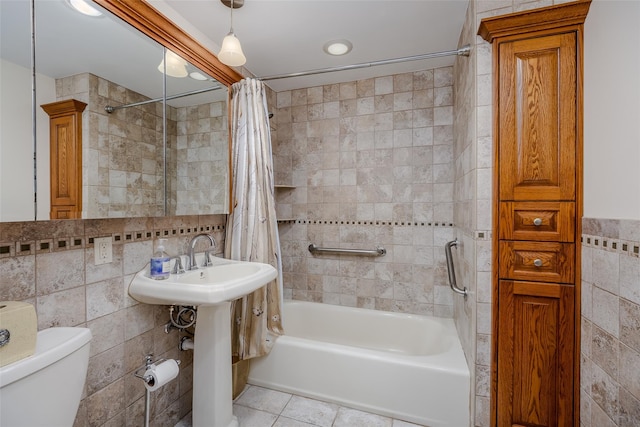 bathroom featuring toilet, tile patterned flooring, tile walls, and shower / bath combo