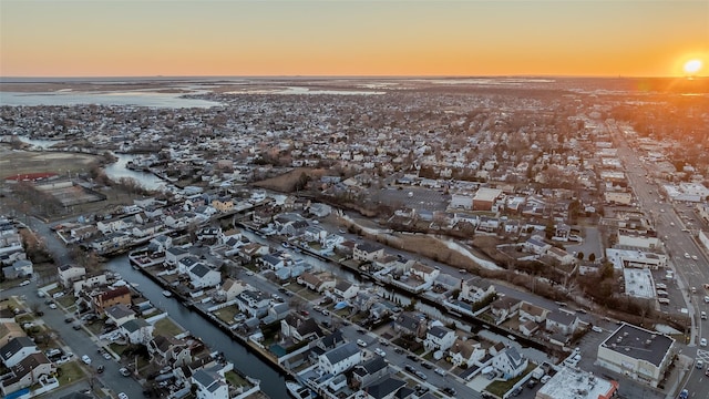 aerial view at dusk with a water view