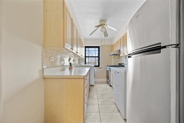 kitchen featuring light brown cabinetry, decorative backsplash, light tile patterned floors, ceiling fan, and stainless steel appliances