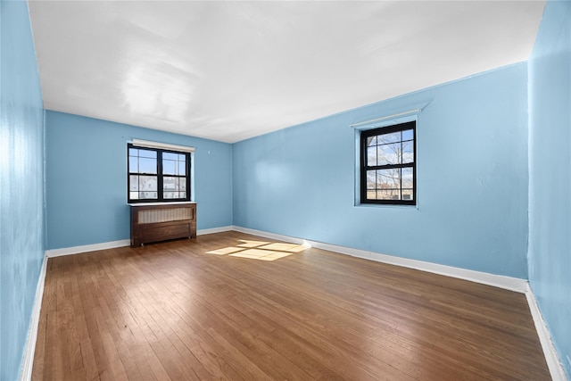 spare room with hardwood / wood-style floors