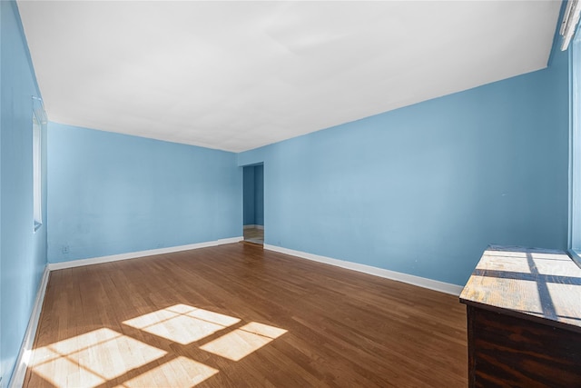 unfurnished room with dark hardwood / wood-style floors