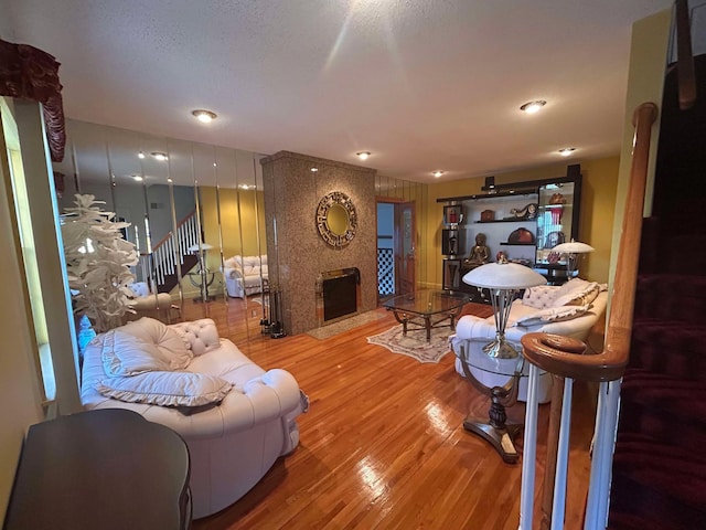 living room with a fireplace and hardwood / wood-style floors