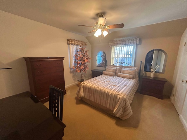 carpeted bedroom with vaulted ceiling and ceiling fan