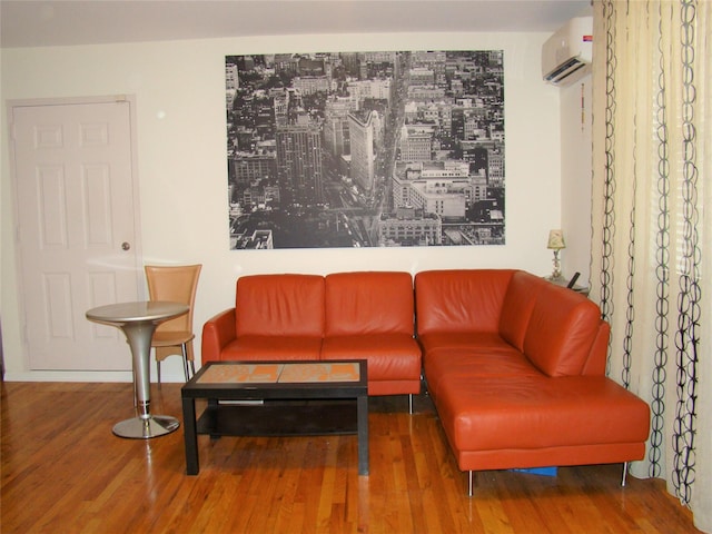 living room with hardwood / wood-style flooring and a wall mounted air conditioner