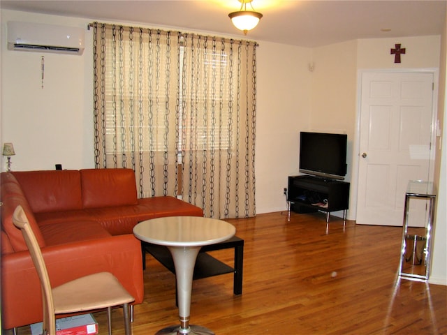 living room with a wall mounted air conditioner and wood-type flooring