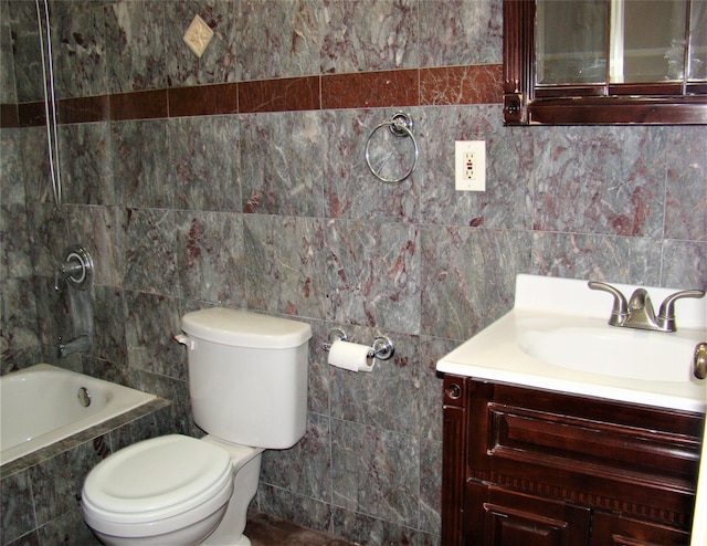 bathroom with a relaxing tiled tub, vanity, toilet, and tile walls