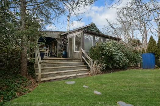 rear view of house with a yard