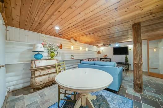 dining area with wood ceiling and ornate columns