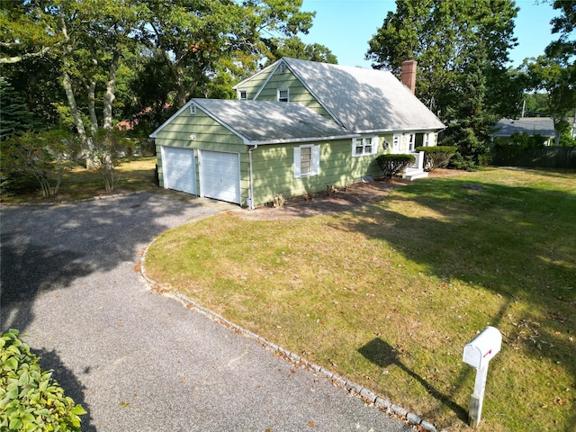 exterior space with a garage and a front yard