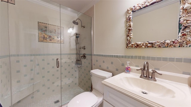 bathroom featuring tile walls, toilet, vanity, walk in shower, and crown molding