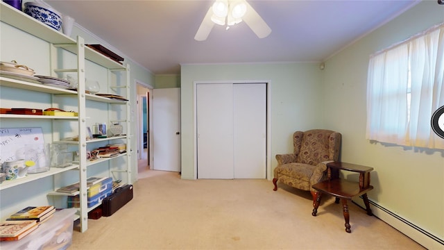 living area featuring baseboard heating, light colored carpet, ornamental molding, and ceiling fan