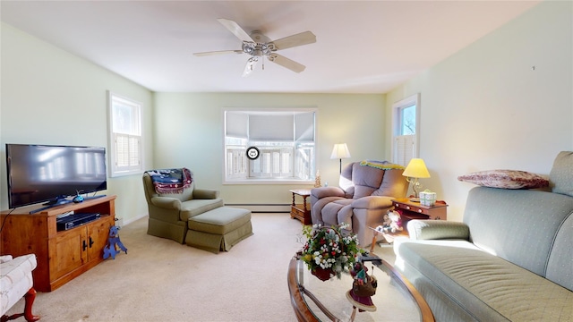 living room featuring a baseboard heating unit, a wealth of natural light, light colored carpet, and ceiling fan