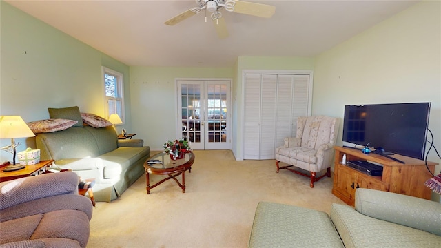 carpeted living room featuring french doors and ceiling fan