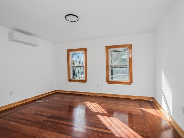 unfurnished room with wood-type flooring and a wall mounted AC