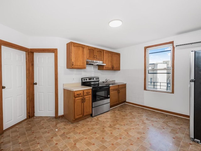 kitchen featuring stainless steel appliances, sink, and a wall mounted AC