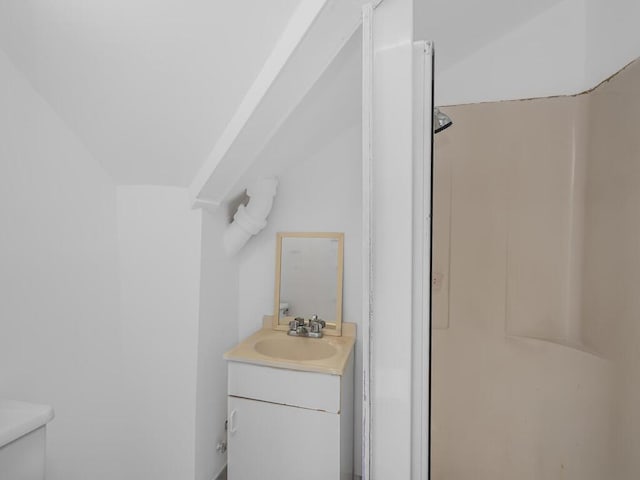 bathroom with vanity, toilet, and walk in shower