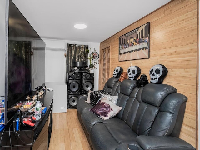 living room with hardwood / wood-style floors and wood walls