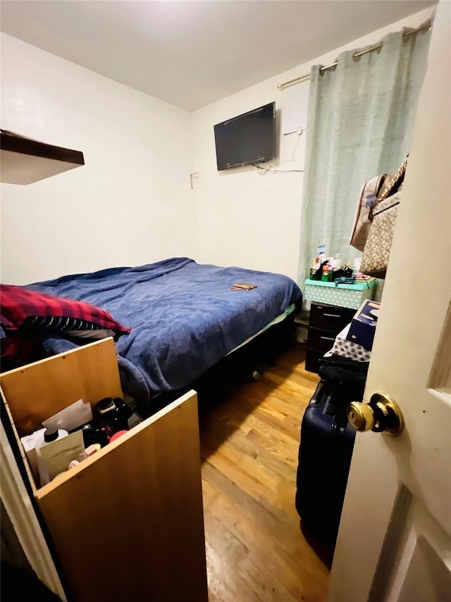 bedroom with hardwood / wood-style floors