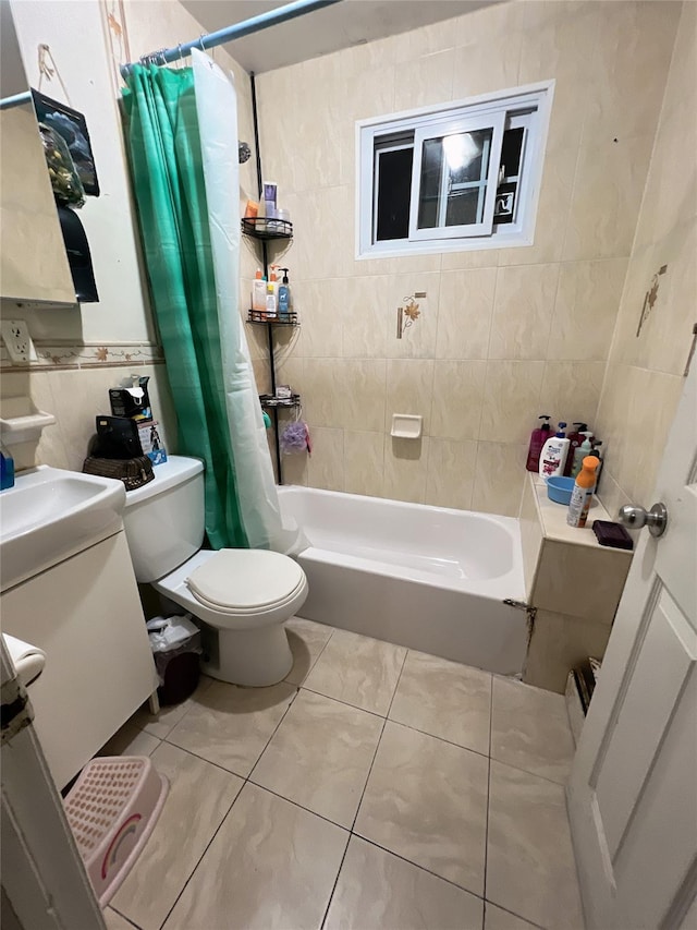 full bathroom featuring tile walls, vanity, shower / bath combination with curtain, tile patterned floors, and toilet