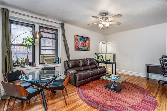 living room with ceiling fan, cooling unit, and light wood-type flooring