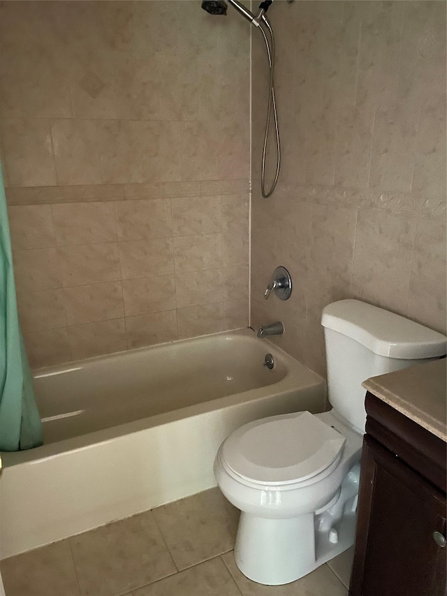 full bathroom featuring tile patterned flooring, toilet, vanity, and shower / bath combo with shower curtain