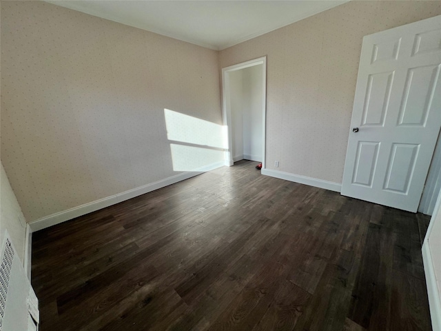 spare room with dark hardwood / wood-style floors