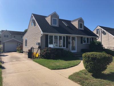 cape cod home with a front yard