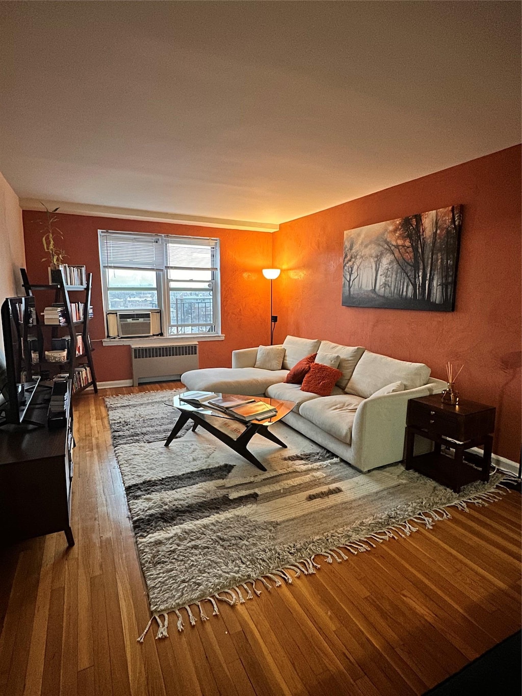 living room with radiator, hardwood / wood-style floors, and cooling unit