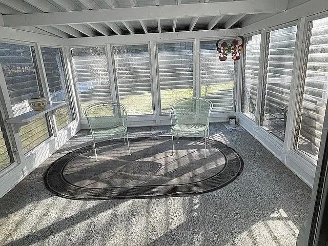 sunroom / solarium with beam ceiling and plenty of natural light