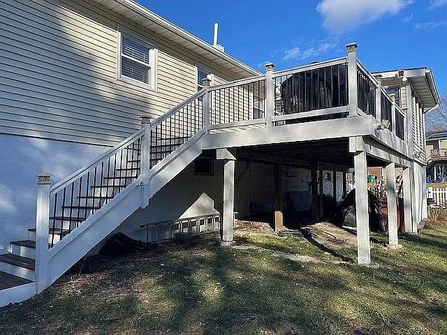 back of property with a wooden deck