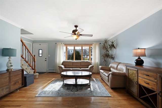 living room with crown molding, a baseboard radiator, and light hardwood / wood-style flooring