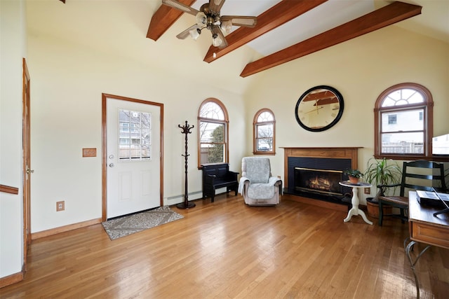 foyer with vaulted ceiling with beams, ceiling fan, light hardwood / wood-style flooring, and a wealth of natural light