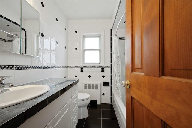 full bathroom featuring tile walls, shower / tub combo, tile patterned flooring, radiator heating unit, and toilet