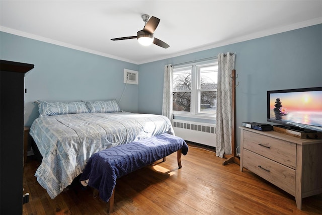 bedroom with radiator, dark wood-type flooring, ornamental molding, and an AC wall unit