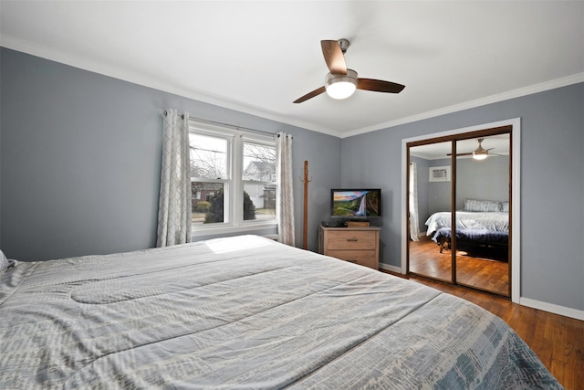 bedroom with ornamental molding, hardwood / wood-style floors, ceiling fan, and a closet