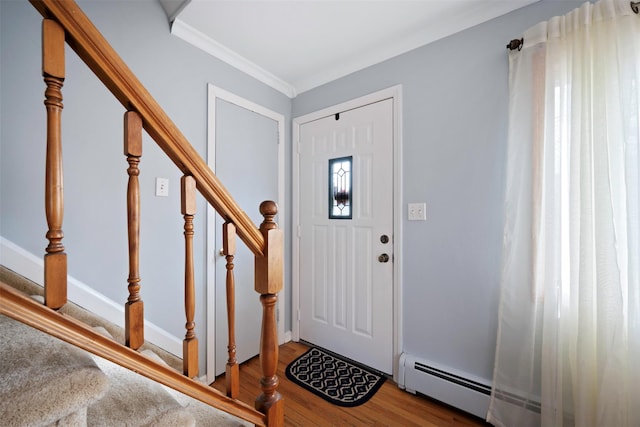 foyer entrance featuring crown molding, hardwood / wood-style floors, and baseboard heating